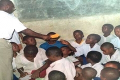 Dr. Mfon Archibong distributing school materials to Secondary school students in Nigeria